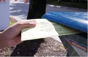  ?? DAVID SANTIAGO dsantiago@miamiheral­d.com ?? Miami-Dade resident James Curity deposits a ballot in a USPS mailbox outside Miami Beach City Hall during early voting for the general election on Wednesday.