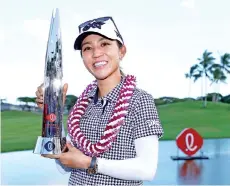  ?? - AFP photo ?? Lydia Ko of New Zealand poses with the trophy after winning the LPGA LOTTE Championsh­ip at Kapolei Golf Club on Saturday.