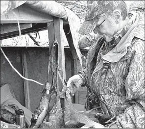  ?? Arkansas Democrat-Gazette/BRYAN HENDRICKS ?? Glen Chase adds a gadwall to the strap Nov. 25 during a duck hunt in Arkansas County.
