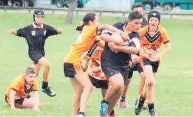  ?? Photo / Supplied ?? A Levin Wanderers U12 player busting through a tackle at the Manawatu Rugby League junior competitio­n.