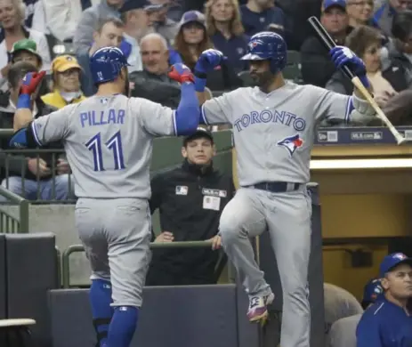  ?? MORRY GASH/THE ASSOCIATED PRESS ?? Outfielder­s Kevin Pillar, left, and Jose Bautista hit two of the Blue Jays’ four home runs on Wednesday, going deep in the fourth inning.