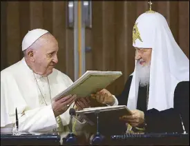  ?? AP ?? Pope Francis and Russian Orthodox Patriarch Kirill exchange a joint declaratio­n on religious unity at the Jose Marti Internatio­nal airport in Havana, Cuba on Friday.