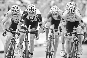  ??  ?? Colombia’s Rigoberto Uran (right) sprints to win ahead of Great Britain’s Christophe­r Froome (left) wearing the overall leader’s yellow jersey, France’s Warren Barguil (second left) and Italy’s Fabio Aru (second right) at the finish line at the end of...