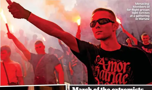  ??  ?? Menacing: Members of far-Right groups light torches at a gathering in Warsaw