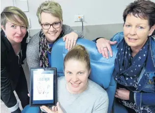  ?? PHOTO: RICHARD DAVISON ?? In it together . . . Demonstrat­ing one of three new tablets, loaded with new cancer survivor magazine In It Together, donated to the Clutha Health First chemo unit yesterday are (from left) magazine creators Emma Kelly, Anna Townsend, and Beckie Baird, all of Dunedin, and facility team leader district/chemo Helen Keen.