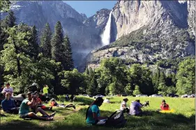  ?? (AP Photo/Scott Smith, File) ?? A class of eighth-grade students and their chaperones sit in a meadow May 25, 2017, at Yosemite National Park, Calif., below Yosemite Falls. Interior Secretary David Bernhardt announced the surprise replacemen­t Friday of the 30-year parks veteran running the National Park Service. Margaret Everson, one of Bernhardt’s advisers, will run the agency as it begins to divvy up a new, multibilli­on-dollar annual bequest from Congress.