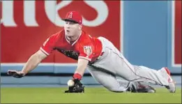  ?? Robert Gauthier Los Angeles Times ?? MIKE TROUT might be known for robbing home runs, but he has worked hard on his fielding. Here he catches a line drive by the Dodgers’ Chris Taylor.