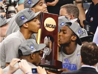  ?? BILL HABER/ASSOCIATED PRESS FILE PHOTO ?? Kentucky’s Anthony Davis, left, and Michael Kidd-Gilchrist, right, kiss the trophy after the NCAA Tournament championsh­ip in 2012 against Kansas. Davis had 16 rebounds, six blocks, five assists and three steals in the Wildcats’ 67-59 win.