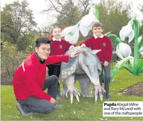  ??  ?? Pupils Abigail Milne and Rory McLeod with one of the craftspeop­le
