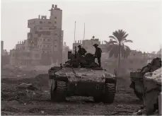  ?? AFP ?? Israeli troops operate in Al Bureij area in the central Gaza Strip, amid their continuing battles with Hamas this week