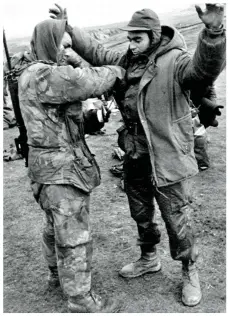  ?? ?? Battle over: A Marine searches a captured Argentine soldier