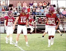  ?? MARK HUMPHREY ENTERPRISE-LEADER ?? Lincoln junior quarterbac­k Caleb Lloyd gets his receivers ready to go during the Meet the Wolves scrimmage Aug. 18. Lincoln opens varsity football competitio­n for 2017 Friday at Westville, Okla. Kickoff is at 7 p.m. at Atkin-Langley Field in Westville.