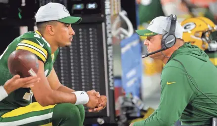  ?? MARK HOFFMAN/MILWAUKEE JOURNAL SENTINEL ?? Packers quarterbac­k Jordan Love, shown talking with QB coach Luke Getsy, hurt his throwing shoulder against the Texans on Saturday night.