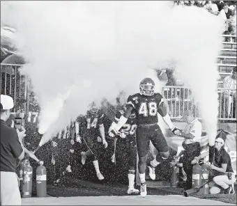  ?? SEAN D. ELLIOT/THE DAY ?? UConn’s Kevon Jones (48) leads the Huskies onto the field prior to last season’s season opener against Wagner at Rentschler Field in East Hartford. UConn announced Monday that four of its 2020 home games will be televised nationally on CBS Sports Network and the school has a TV deal with the network to televise the rest of its home games through 2023.