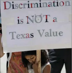  ??  ?? A young girl holds a sign as protesters gather on the steps of the Texas Capitol while State lawmakers begin a special legislativ­e session called by Republican Gov. Greg Abbott in Austin, Texas, on Tuesday. AP PHOTO/ERIC GAY