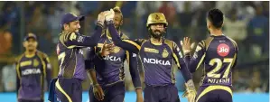  ?? AFP ?? KKR captain Dinesh Karthik (second from right) celebrates the wicket of Rajasthan Royals captain Ajinkya Rahane with Robin Uthappa (left) and other teammates on Wednesday. —