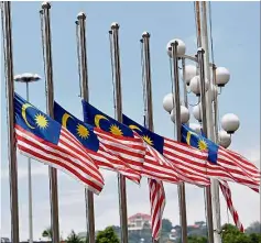  ??  ?? Nation in mourning: The Jalur Gemilang being flown at
half-mast at the Putra World Trade Centre in Kuala Lumpur.