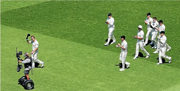  ?? GETTY IMAGES ?? Neil Wagner is applauded off the Basin Reserve by his Black Caps team-mates after taking seven wickets on the first day of the test against the West Indies in Wellington last December.