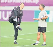  ?? — AFP photo ?? Germany coach Hans-Dieter Flick talk with goalkeeper Manuel Neuer during a training session.