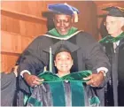  ?? FAMILY PHOTOGRAPH ?? Dr. Mysheika Roberts gets hooded by her father, Dr. Robert Lemailewil­liams, as she graduates from the University of Maryland School of Medicine in 1998.