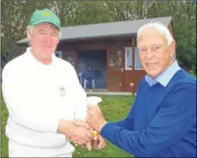  ??  ?? Canterbury Croquet Club chairman Barry Sales presents the winner’s trophy to Jonathan Lamb