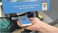 ?? COURTESY OF WHOLE FOODS MARKET ?? One of the ways Prime members can receive discounts at Whole Foods is by scanning the store’s app at checkout.