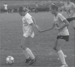  ?? STAFF PHOTO BY ANDY STATES ?? North Point’s Jordan Felton works with the ball in front of Chopticon’s Riley Long during the teams’ game at Chopticon on Wednesday night. Felton scored a goal in the Eagles’ 2-1 win.