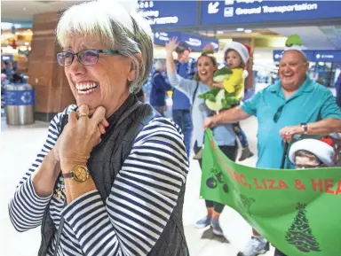  ??  ?? Pat Walsh of Queen Creek sets eyes on her son, Marc Walsh, in Sky Harbor Internatio­nal Airport’s Terminal 4 on Thursday, as Marc and his wife and daughter arrive from Sydney, Australia.