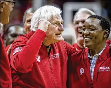  ?? AP ?? Bob Knight makes his first appearance at Indiana since he was fired in September 2000. Knight and ex-player Isiah Thomas (right) were on the court during a ceremony with Indiana players of the 1980 Big Ten championsh­ip team.