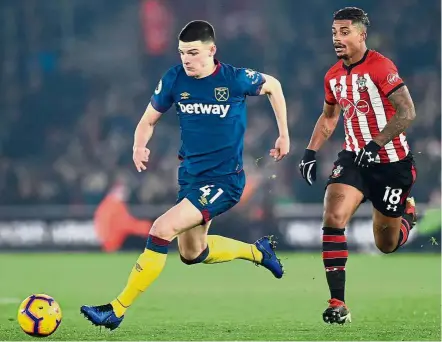  ?? — AFP ?? Important signing: West Ham’s Declan Rice (left) dribbling past Southampto­n’s Mario Lemina during the Premier League match at St Mary’s on Thursday.