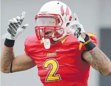  ?? CRYSTAL SCHICK/ CALGARY HERALD ?? University of Calgary’s Dino’s Rashaun Simonise celebrates after scoring a touchdown in a 59- 19 win over the University of Saskatchew­an Huskies at McMahon Stadium on Saturday.