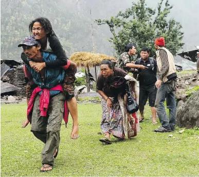  ?? SAJJAD HUSSAIN/AFP/GETTY IMAGES ?? An injured Nepalese resident is carried to an Indian army helicopter in Gorkha on Tuesday. Delays in the shipment of aid will be exacerbate­d by the logistical difficulti­es presented by Nepal’s geography, writes Michael Den Tandt.