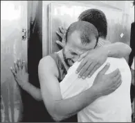  ?? AP/HATEM ALI ?? Palestinia­ns comfort each other Monday at the morgue of al-Najar hospital after one of their relatives was killed in an Israeli airstrike on their family’s home in Rafah in the southern Gaza Strip.