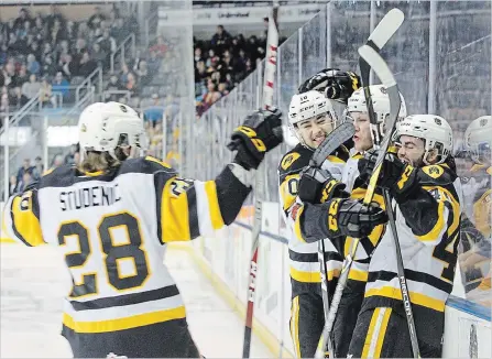  ?? JULIA MCKAY THE WHIG-STANDARD ?? Hamilton Bulldogs celebrate with teammate Benjamin Gleason after he scored the first goal of the game Sunday in Kingston just 1:16 into play.