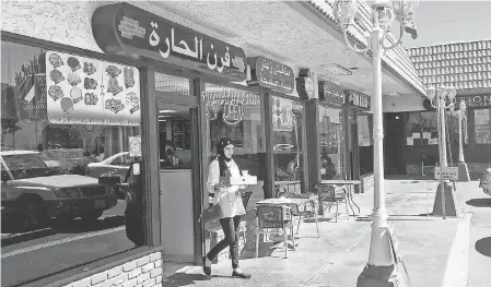  ?? GILLIAN FLACCUS/ AP ?? A customer exits a Lebanese eatery in Anaheim’s “Little Arabia” neighborho­od miles from Disneyland in Orange County. Southern California is home to the nation’s largest concentrat­ion of Arab Americans.