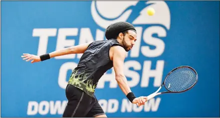  ??  ?? Germany’s tennis player Dustin Brown returns the ball during a pro-tennis tournament at a local base tennis academy in Hoehr-Grenzhause­n, western
Germany, on May 1. (AP)