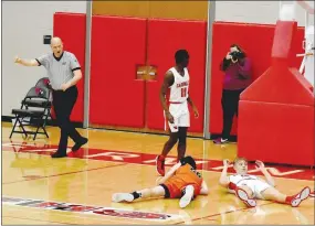  ?? MARK HUMPHREY ENTERPRISE-LEADER ?? Farmington’s James Payne (right on floor) drew a charging foul, taking away a made 3-pointer by Gravette on this play. The Cardinals won the 4A-1 boys basketball game at Cardinal Arena, 77-64, on Tuesday, Jan. 19.