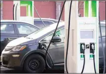  ??  ?? In this file photo, a Chevrolet Bolt charges at an Electrify America site outside Colorado Mills outlet mall in downtown Lakewood, Colorado. (AP)