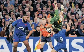  ?? | AFP ?? SPRINGBOK wing Cheslin Kolbe is taken out in the air by France scrumhalf Antoine Dupont in Marseille on Saturday night.