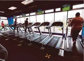  ?? FILE PIC ?? People working out at a gym in Kuala Lumpur in June last year following the implementa­tion of the Recovery Movement Control Order.