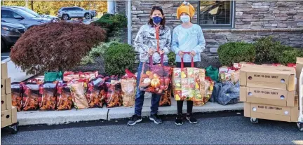  ?? SUBMITTED PHOTO ?? In a Thanksgivi­ng food drive challenge, Kim Evans, left, collected 27 meals and Kelsea Gibson, 11, took the win with 46 meals. Their combined total of 73 Thanksgivi­ng meals, weighing 2,610 pounds, was donated to Preston’s Pantry of Boyertown Area Multi-Service.