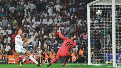  ?? AFP ?? Real Madrid’s Cristiano Ronaldo scores past APOEL Nicosia’s goalkeeper Boy Waterman that was eventually cancelled by line referee during the Champions League match at the Santiago Bernabeu stadium in Madrid on Wednesday.