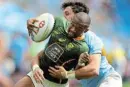  ?? Photograph: MARK METCALFE/ GETTY IMAGES ?? WINNING FEELING: Shaun Williams of SA is tackled during the Sydney Sevens match against Uruguay in Australia on January 28