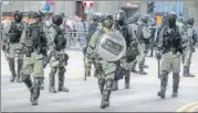  ?? AP ?? Police in riot gear arrive at the scene of a protest in the financial district in Hong Kong on Friday.