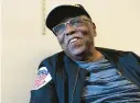  ?? ?? Bishop D.E. Hicklin Sr. talks about his grandson, Larnelle Damon, who is a thirdgener­ation barber.