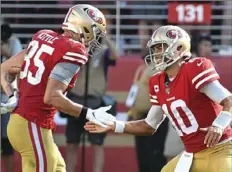  ??  ?? San Francisco’s George Kittle, left, and Jimmy Garoppolo celebrate after the game-winning touchdown.