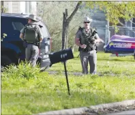  ?? AP PHOTO ?? Law enforcemen­t officers secure the neighborho­od at the scene of Walnut and 2nd Street in Pflugervil­le, Texas, on Wednesday where Austin, Texas bombing suspect Mark Anthony Conditt lived.