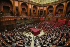  ?? Gregorio Borgia/Associated Press ?? Lawmakers applaud after Sergio Mattarella is re-elected as Italy’s 13th president Saturday at the end of the eighth round of voting in the Italian parliament in Rome.