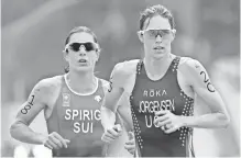  ?? ERICH SCHLEGEL, USA TODAY SPORTS ?? The USA’s Gwen Jorgensen, right, outran Switzerlan­d’s Nicola Spirig to win gold in the women’s triathlon Saturday.