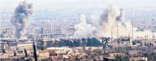  ??  ?? A picture taken from a regime-controlled area on the outskirts of Harasta on the northeaste­rn suburbs of Damascus on Wednesday, shows smoke rising from areas targeted by regime forces shelling in the towns of Douma and Harasta. (AFP)